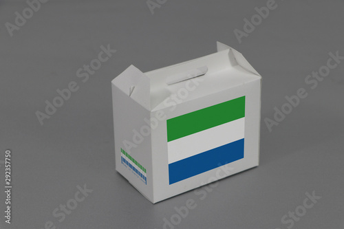 Sierra leonean flag on white box with barcode and the color of nation flag on grey background. The concept of export trading from Sierra leone. photo