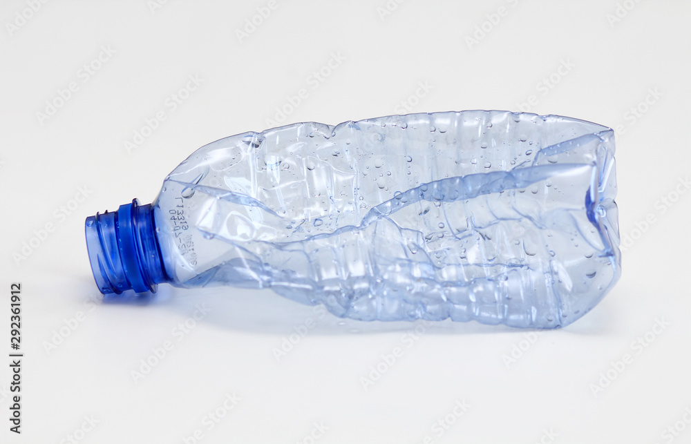 Single empty blue plastic bottle on white background. Waste recycling concept. Garbage. Isolation on white. Single empty blue plastic bottle on white background. Waste recycling concept. Garbage. Isolation on white.