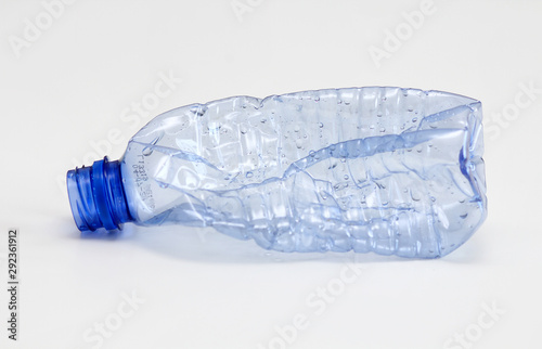 Single empty blue plastic bottle on white background. Waste recycling concept. Garbage. Isolation on white. © exienator