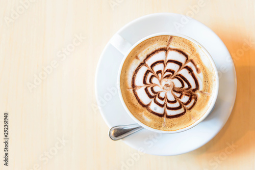 Top view of hot coffee on table / hot cappuccino with nice pattern milk foam 