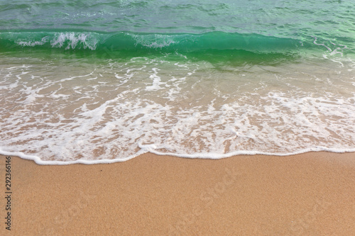 Sand beach water surf. Green sea wave.