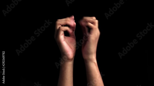 Pair of human hands coming up and doing famous popular Namaste or Namaskar and Namaskaram or nameste hand gesture or yoga mudra isolated on black.Greeting the one in the camera. photo