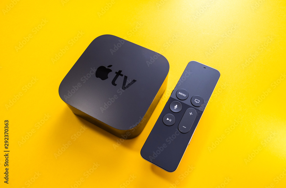 Paris, France - 25 Mar 2019: Modern vivid yellow background with Apple TV 4k  player with Siri