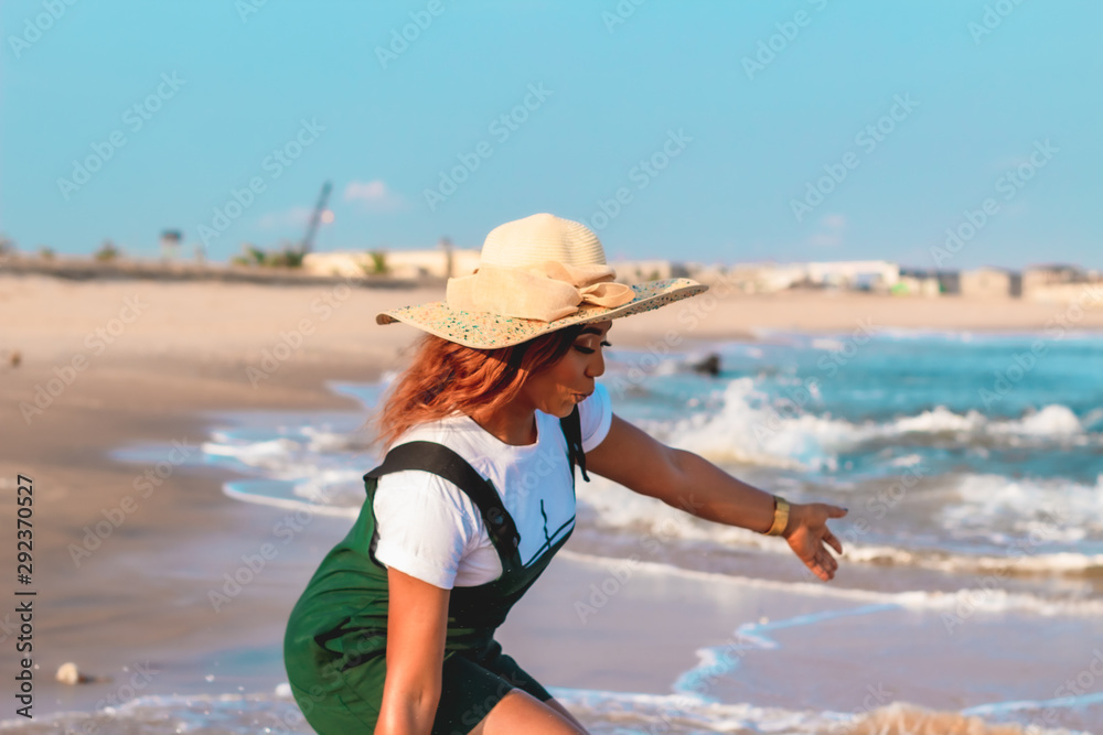 Woman touching the ocean waves on the beach