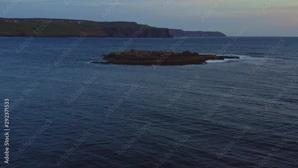 Aerial of Crab Island and Cliffs of Moher on background at blue hour Aerial of Crab Island and Cliffs of Moher on background at blue hour