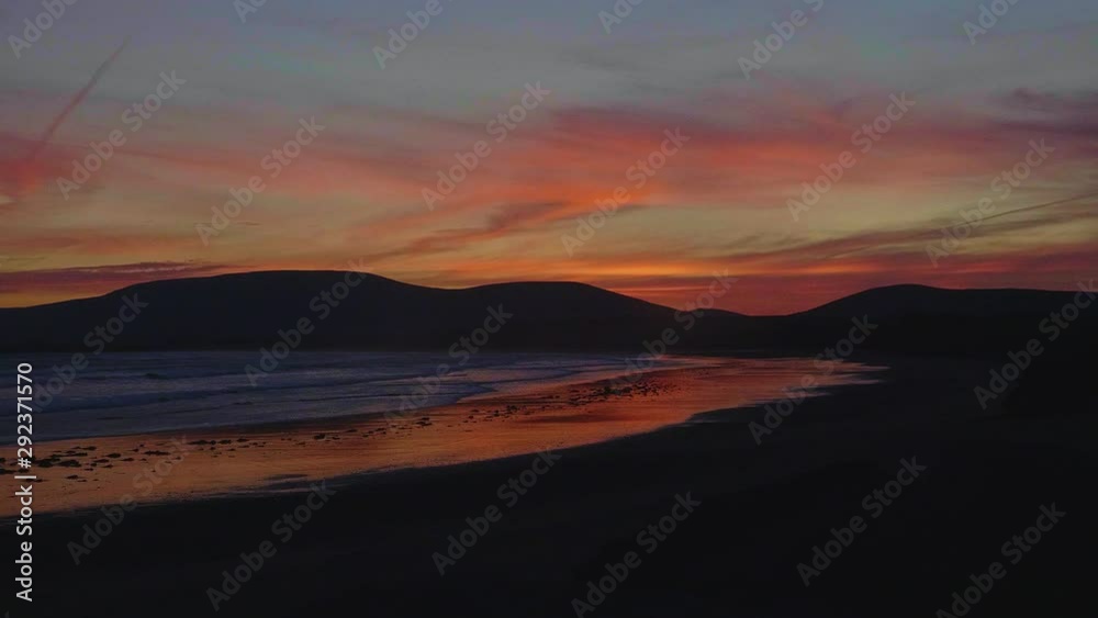 Slow motion of an incredible sunset at the beach in Ireland coast
