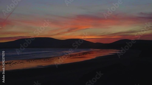 Slow motion of an incredible sunset at the beach in Ireland coast photo