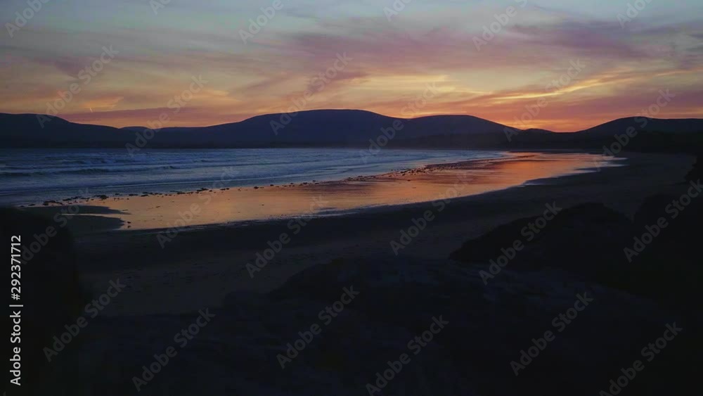 Spectacular seascape with colorful sunset sky on the coast of Waterville, Ireland. SLOW MOTION