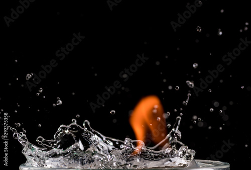 burning drink, splash and fire on a black background