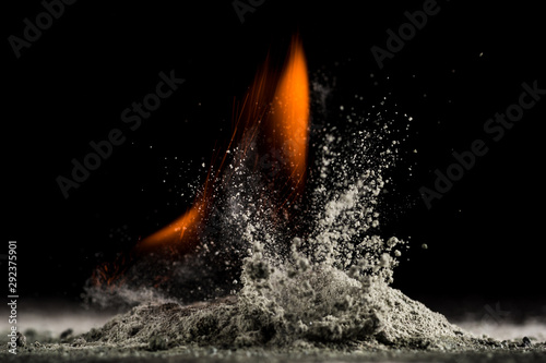 burning sand and a splash of water on a black background, the fifth element