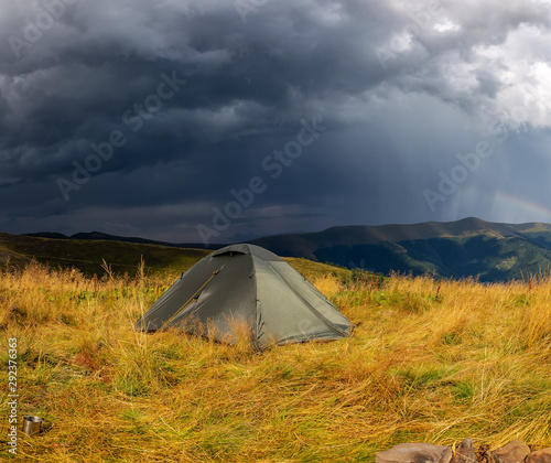 Beautiful mountain landscape in stormy weather with a tourist tent. Carpathian mountains of Ukraine. Holidays in the mountains.