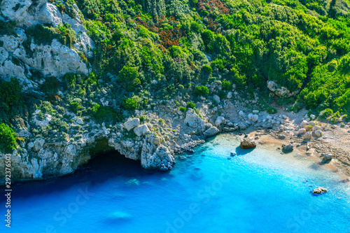 Beautiful summertime panoramic seascape. Awesome view picturesque green slopes coastline sea with crystal clear azure water. Unique secluded beach.