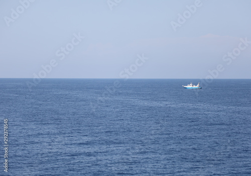 water of the ocean and the blue sky with fishing boat © ChiccoDodiFC