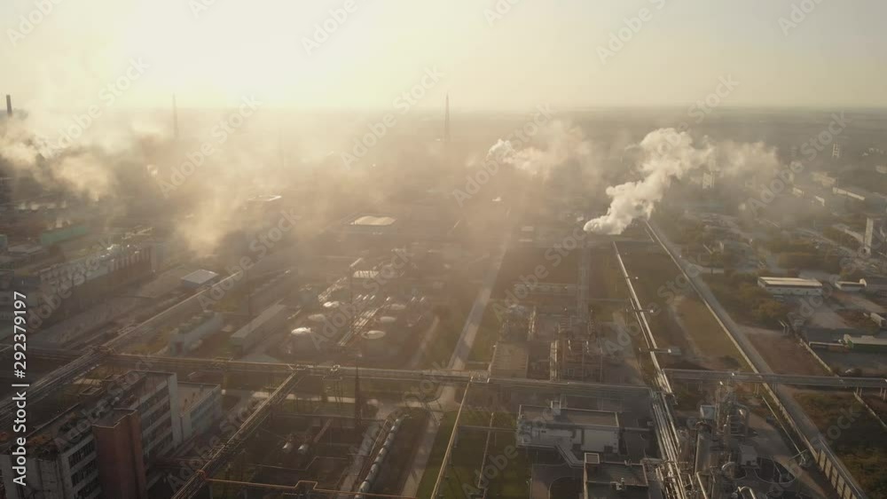 Aerial view. In the frame is a chemical industrial complex. Many factory chimneys spew smoke. Atmospheric pollution is ongoing. Aerial view. In the frame is a chemical industrial complex. Many factory chimneys spew smoke. Atmospheric pollution is ongoing.
