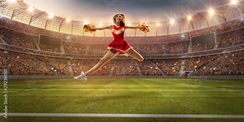 A cheerleader in action on the professional stadium. Stadium and crowd are made in 3d. photo