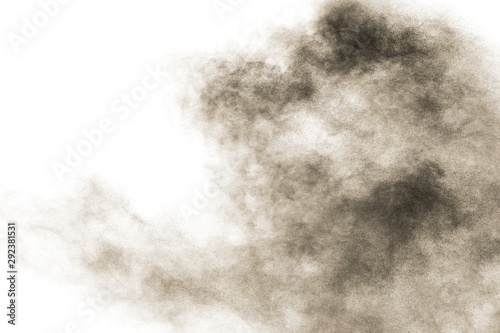 Freeze motion of brown dust explosion.Stopping the movement of brown powder. Explosive brown powder on white background.