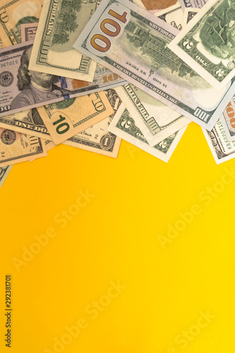 One hundred dollar banknotes on colored background top view, with empty place for your text business money concept.