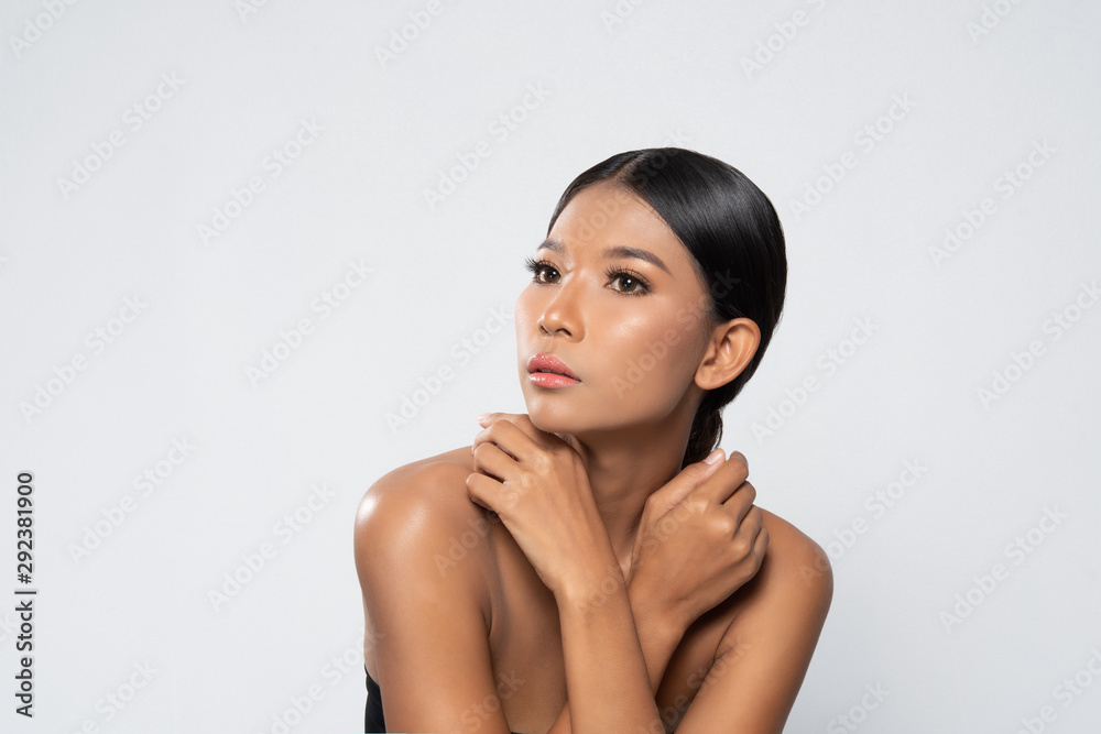 Beautiful black woman with clean fresh skin, Proposing a product. Gestures for advertisement isolated on white background