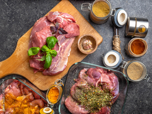 Raw meat with herbs , spices, sauces on concrete background. Top view