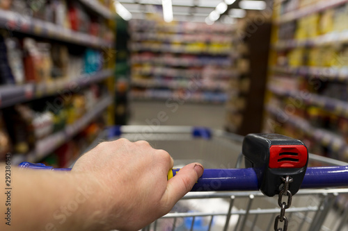 man with trolley in supermarket photo