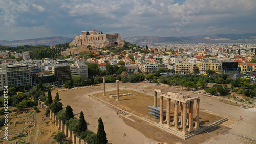 Aerial photo of iconic pillars of Temple of Olympian Zeus and world famous Acropolis hill with masterpiece Parthenon on top at the background, Athens historic centre, Attica, Greece