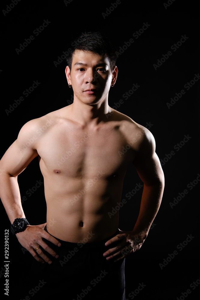 Fototapeta premium athletic muscular bodybuilder man with naked torso six pack abs. fitness workout concept