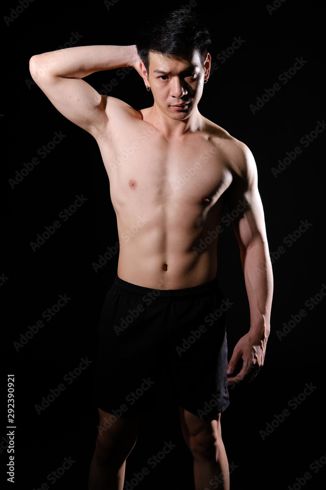 athletic muscular bodybuilder man with naked torso six pack abs. fitness workout concept