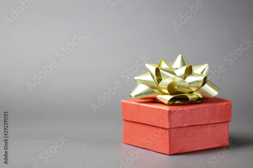 Christmas red gift box on grey background.