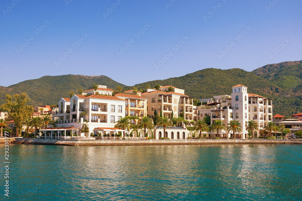 Beautiful view of embankment of Tivat city from sea on sunny day. Montenegro, Adriatic Sea, Kotor Bay