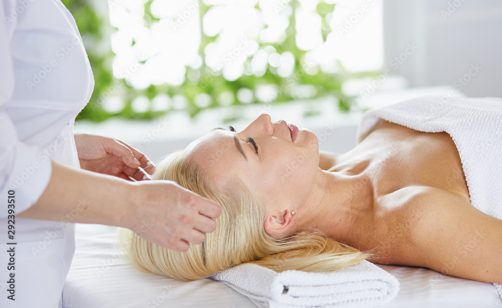 Beautiful woman with closed eyes getting a massage in the spa s Beautiful woman with closed eyes getting a massage in the spa s