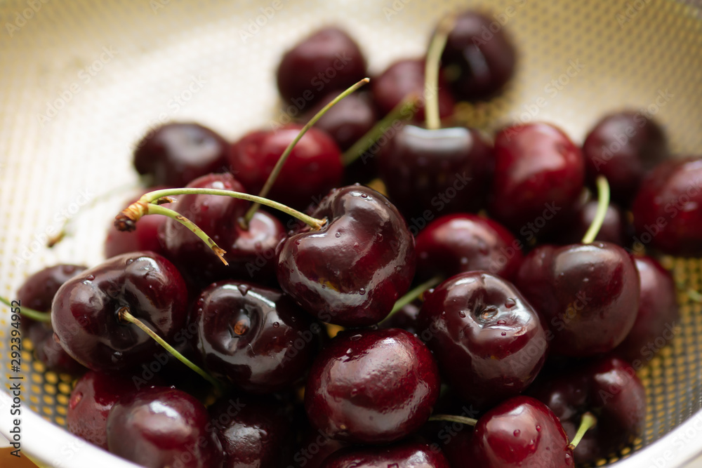 Fresh cherries in fruit washing colander Fresh cherries in fruit washing colander