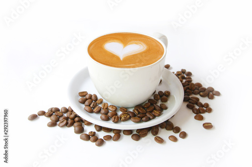 Coffee cup with latte art heart shape and beans isolated on a white background.