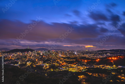 Seoul downtown cityscape illuminated with lights and Namsan Seoul Tower in the evening view from Inwang mountain. Seoul  South Korea.