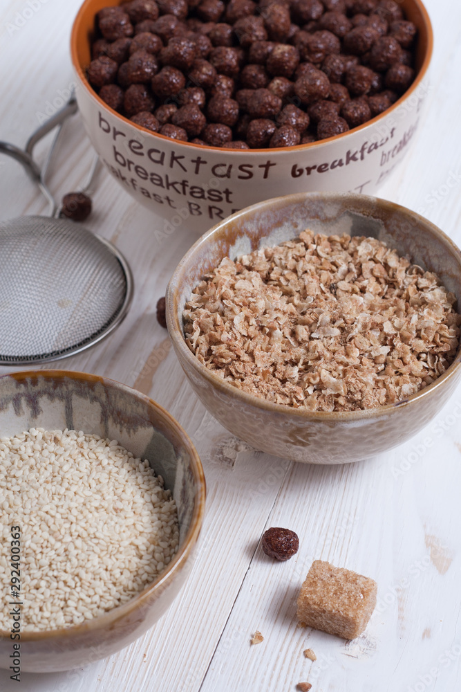 Flakes, sugar, seeds semi-cook for porridge close up in white key Flakes, sugar, seeds semi-cook for porridge close up in white key