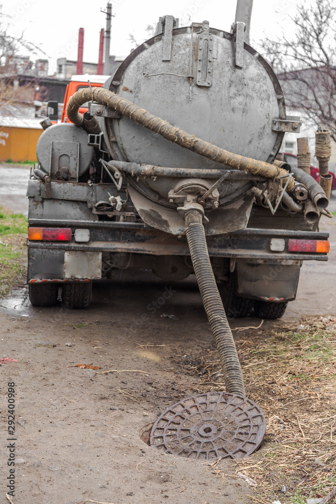 The special machine pumps out and cleans the sewer manhole from the sewer household waste
