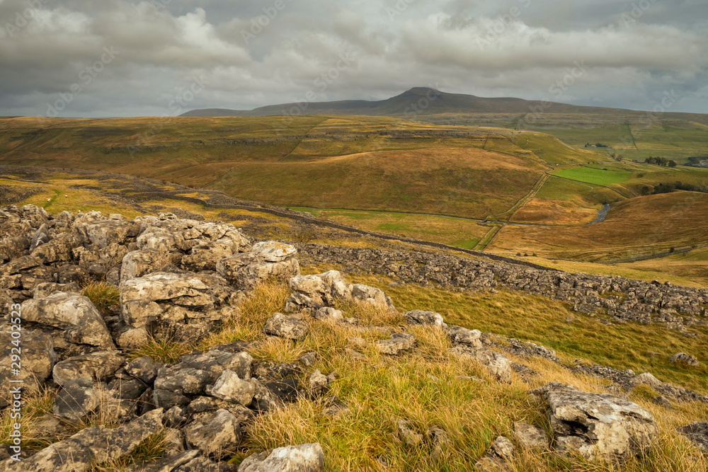 The Cheese Press Stone above Ingleton and with brooding Ingleborough in the background. These stones are 'fragments' of the magnificent limestone scenery of the Yorkshire Dales.