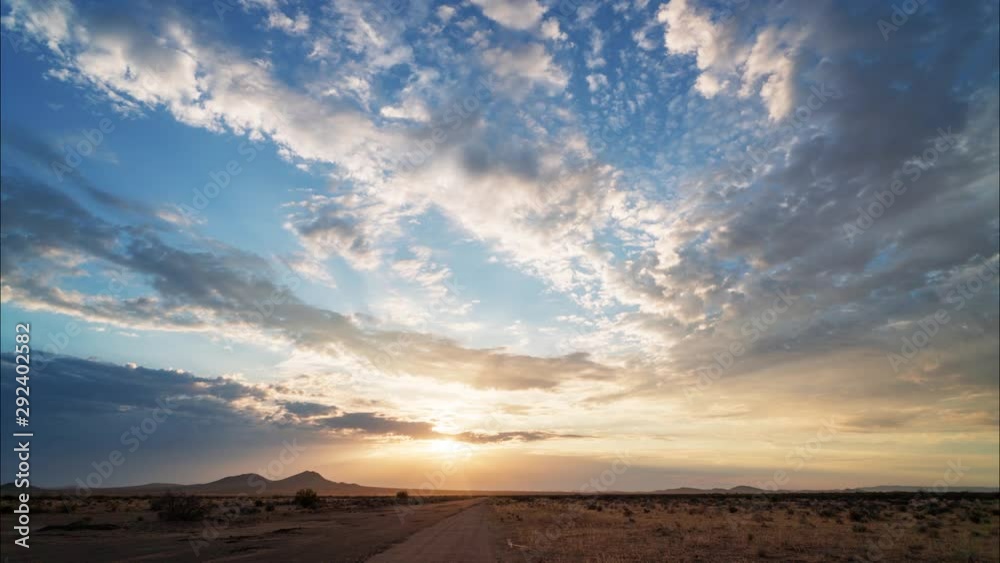 Golden sun flare shining through clouds in Mojave Desert, Timelapse Golden sun flare shining through clouds in Mojave Desert, Timelapse