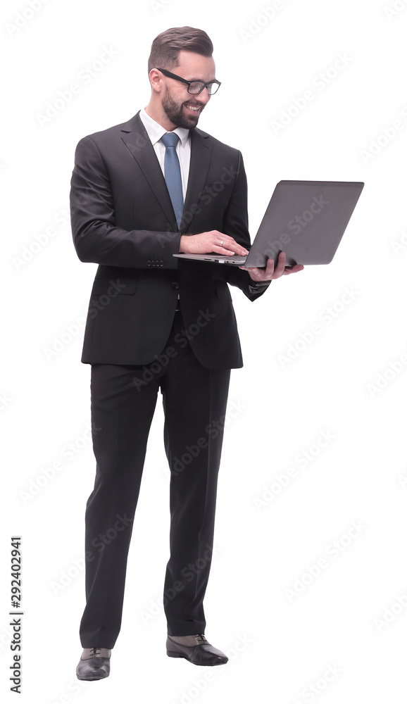 in full growth. businessman with open laptop. in full growth. businessman with open laptop.