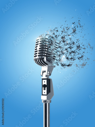 Retro microphone isolated in blue background with explodation effect photo