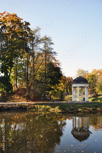 Autumn landscape of the lake surrounded by a city Park.