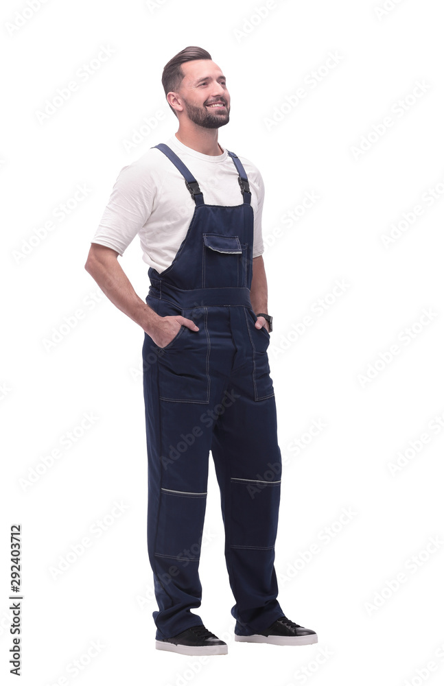 side view. smiling man in overalls looking forward to copy space side view. smiling man in overalls looking forward to copy space