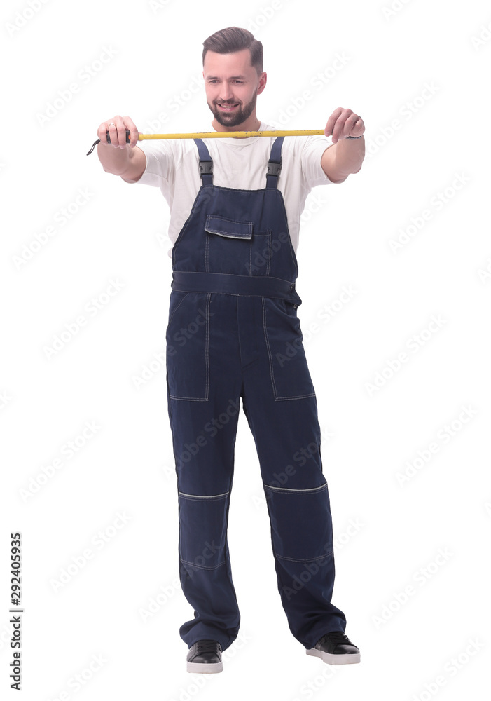 in full growth. smiling man with construction tape measure in full growth. smiling man with construction tape measure