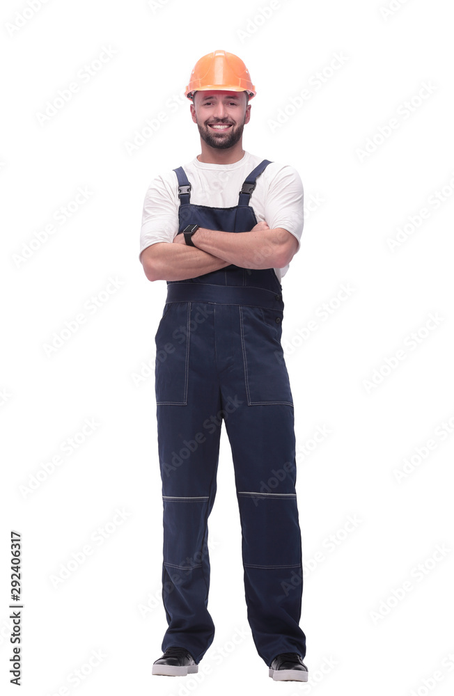 in full growth. smiling man in overalls and a safety helmet