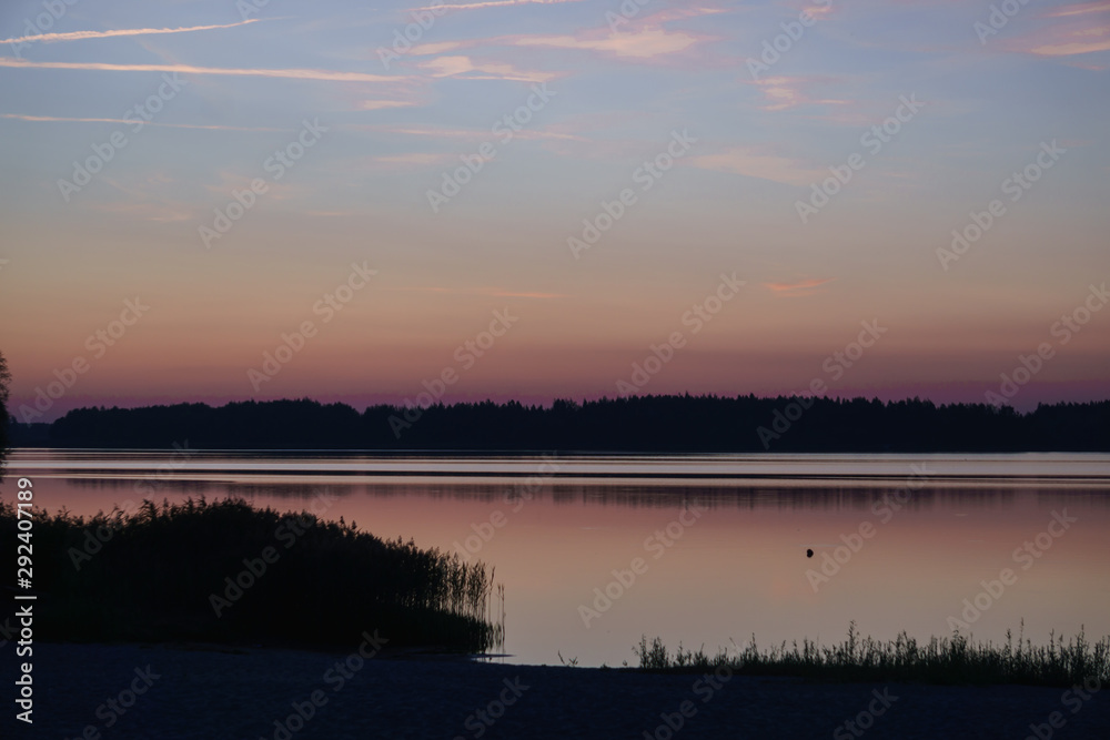 Fototapeta premium Beautiful sunny sunset over the lake. Evening landscape.