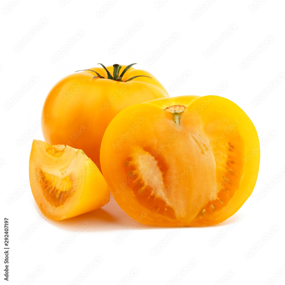 Yellow whole tomato with a slice. Isolated on white background. Yellow whole tomato with a slice. Isolated on white background.