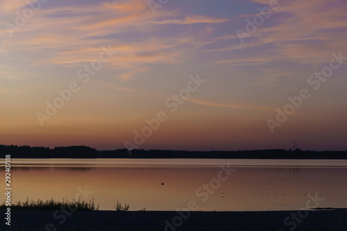 Fototapeta Naklejka Na Ścianę i Meble -  Beautiful sunny sunset over the lake. Evening landscape.
