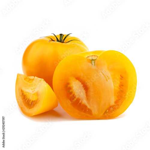 Yellow whole tomato with a slice. Isolated on white background.