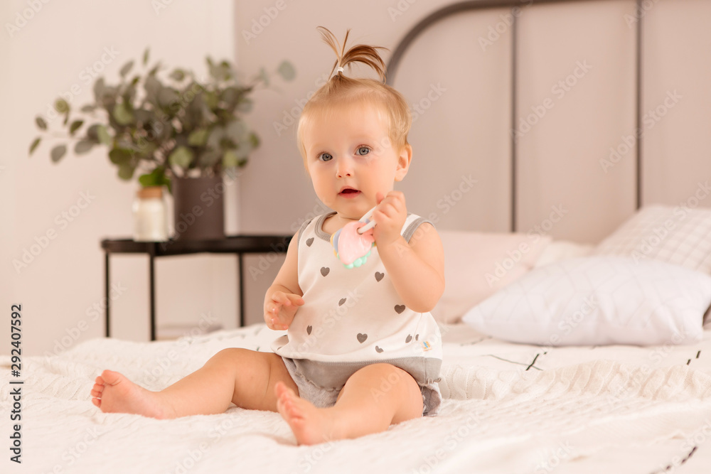 baby girl plays in a bedroom,Portrait Of Smiling Baby Girl Sitting On Bed baby girl plays in a bedroom,Portrait Of Smiling Baby Girl Sitting On Bed