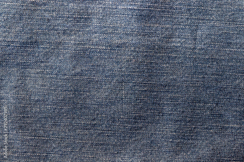 Top view of denim jeans texture. Canvas jeans background of dark blue color with details