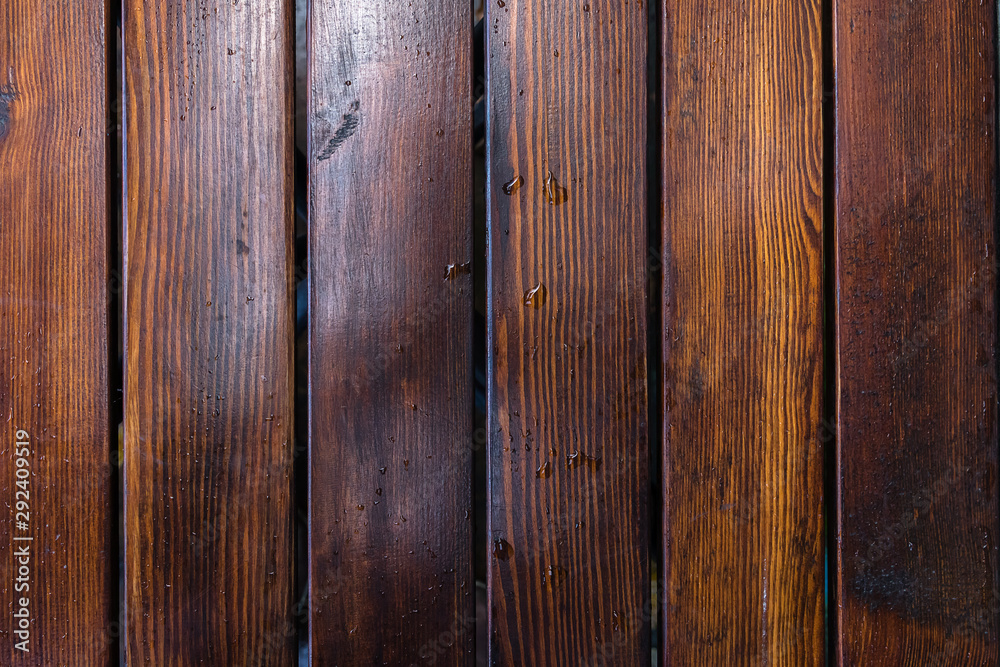 Naklejka premium Dark brown boards background with spots. Old wet wood texture pattern after rain with reflections